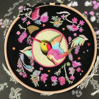 embroidered circle with hummingbird on black background and a lot of texture, frontal view, neon iridescent colors, embroidery style