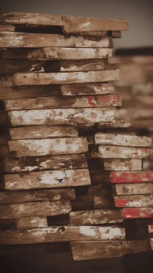 old wooden boards stacks together with flaky old paint on them in a studio setting, studio lighting, trending on artstation, photography, intricate detail